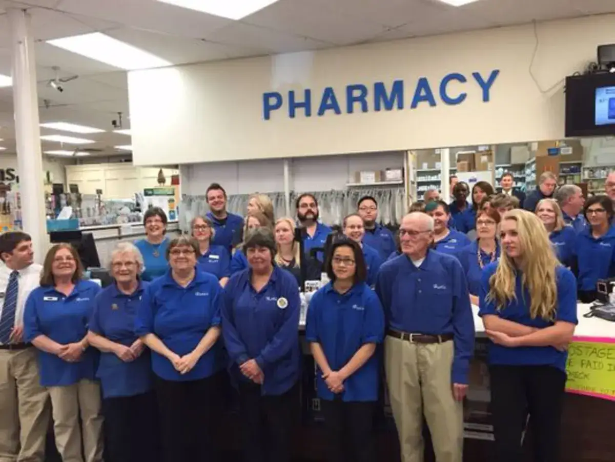 Hunt's staff gathered in front of the pharmacy counter